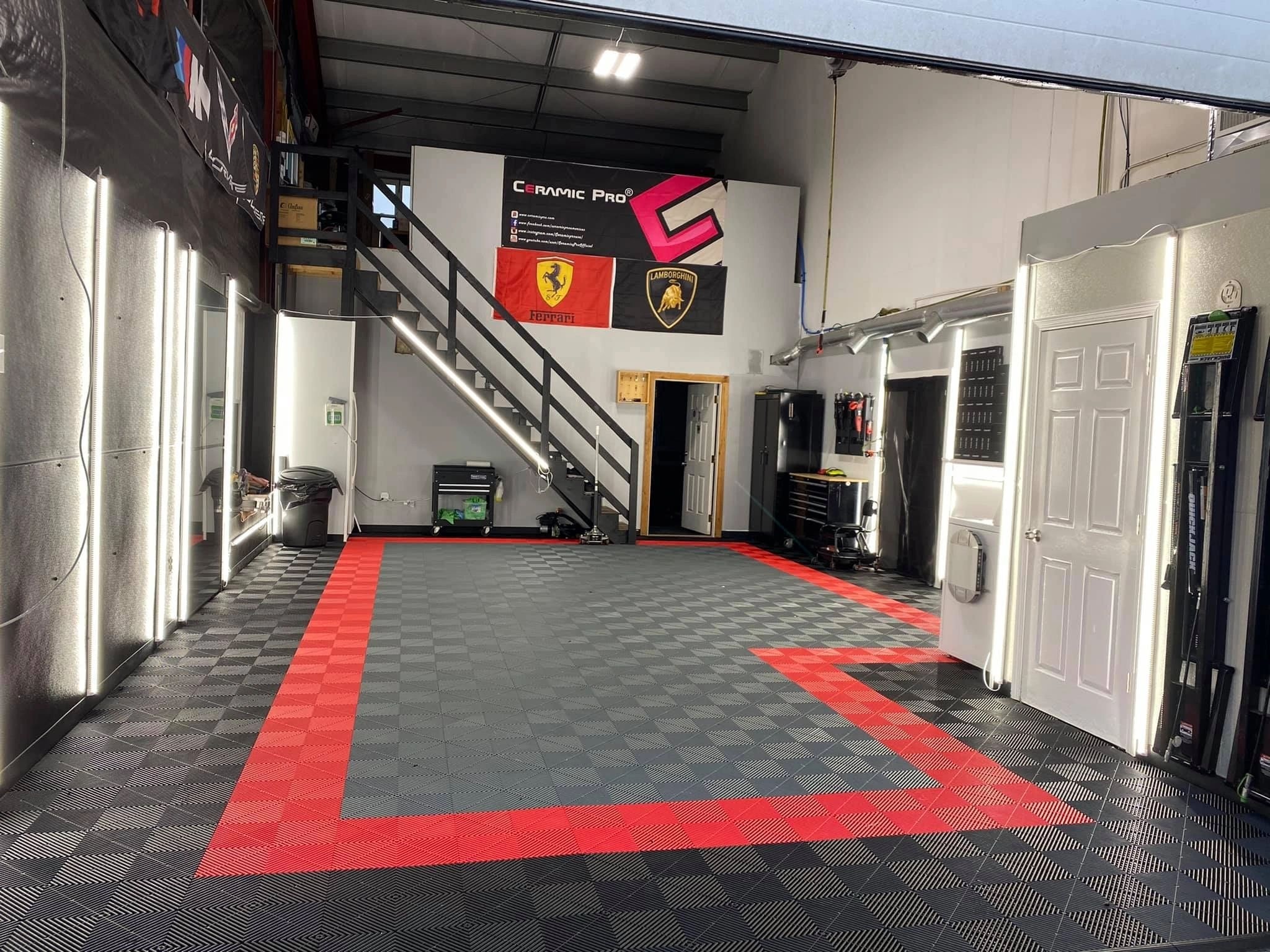 ATD shop interior with Ferrari and Lamborghini flags